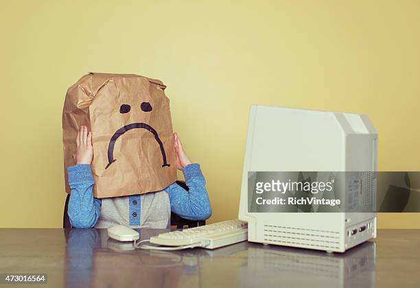 sad paper bag boy is cyber bullying victim - rich fury stock pictures, royalty-free photos & images
