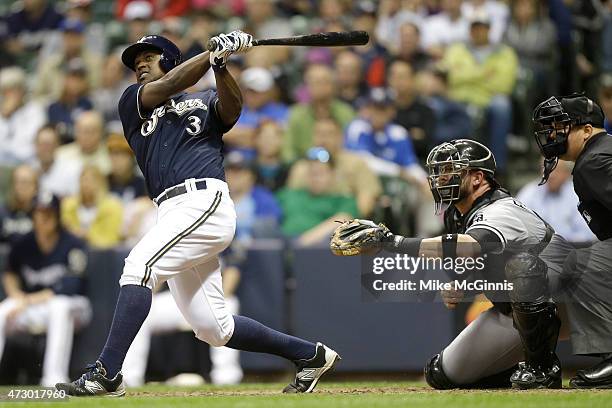 Elian Herrera of the Milwaukee Brewers hits a two run homer in the eighth inning during the interleague game against the Chicago White Sox at Miller...