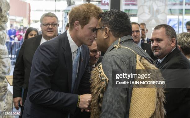 Britain's Prince Harry receives a "hongi", a traditional Maori greeting, upon his arrival for a tour of the 'Quake City' Museum, showing artifacts...