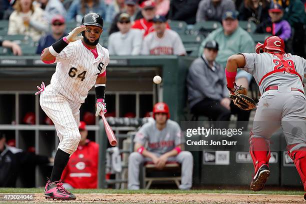 Tucker Barnhart of the Cincinnati Reds is unable to catch a wild pitch by Jumbo Diaz of the Cincinnati Reds while Emilio Bonifacio of the Chicago...