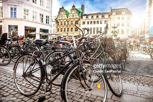 copenhagen bycicle parked in a town square - copenhagen stock pictures, royalty-free photos & images
