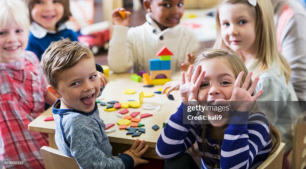 Playful preschoolers having fun making faces