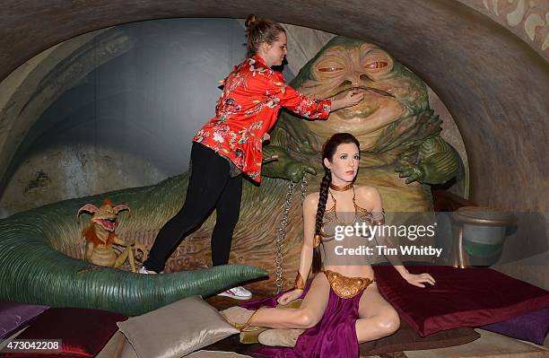 Member of staff makes a last minute touch up of wax figure Jabba The Hut, from Star Wars, on display at 'Star Wars At Madame Tussauds' on May 12,...