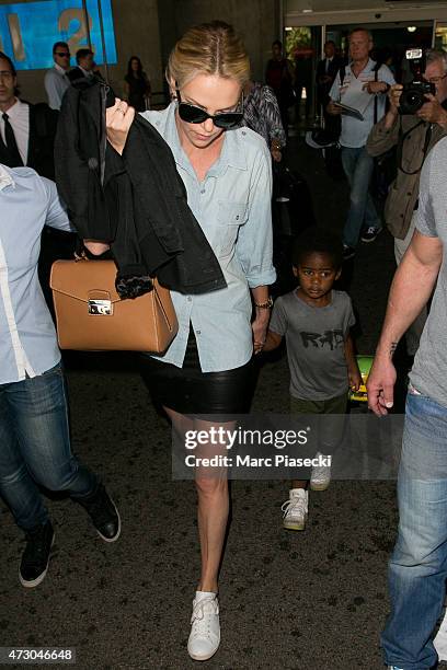 Actress Charlize Theron and her son Jackson arrive at the Nice airport ahead the 68th annual Cannes Film Festival on May 12, 2015 in Cannes, France.