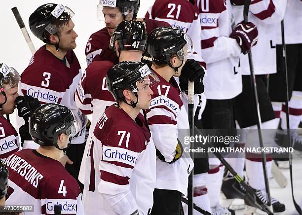 Players of team Latvia react after loosing a penalty shootout during the group A preliminary round match Latvia vs France at the 2015 IIHF Ice Hockey...