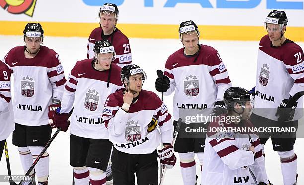 Players of team Latvia react after loosing a penalty shootout during the group A preliminary round match Latvia vs France at the 2015 IIHF Ice Hockey...