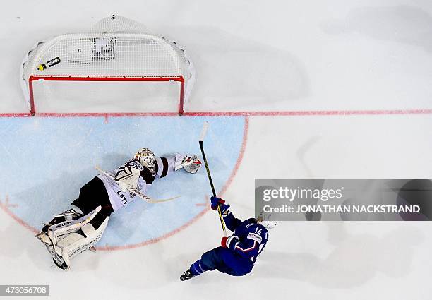 Forward Stephane da Costa of France shoots to score the game winning goal past goalkeeper Edgars Masalskis of Latvia at a penalty shootout after...