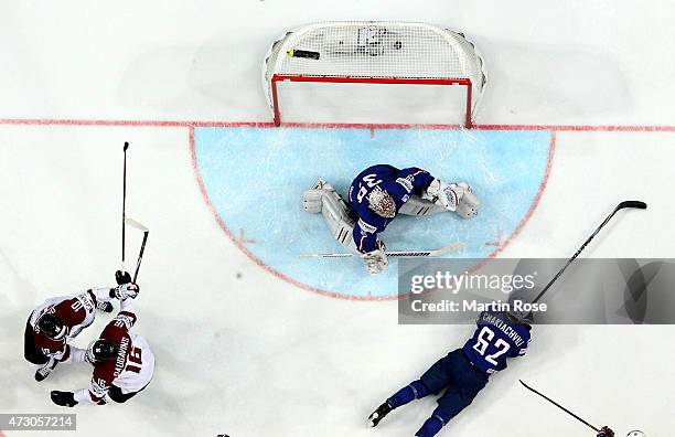 Kaspars Daugavins of Latvia celebrate with his team mates after he scores the opening goal during the IIHF World Championship group A match between...