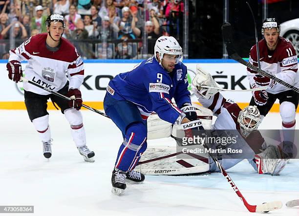 Damien Fleury of France fails to score over Edgars Masalskis, goaltender of Latvia during the IIHF World Championship group A match between Latvia...
