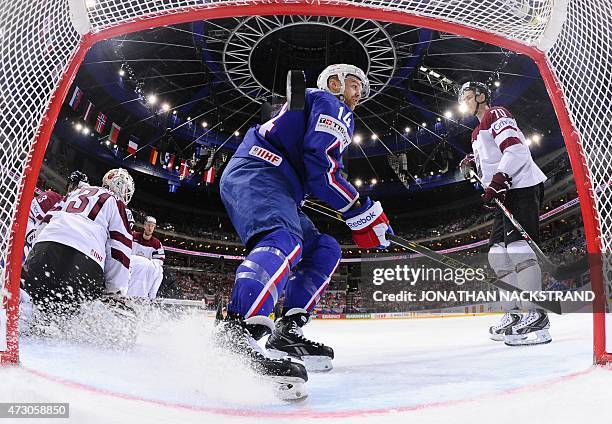 Forward Stephane da Costa of France brakes as he scores past goalkeeper Edgars Masalskis of Latvia during the group A preliminary round match Latvia...