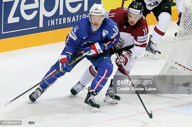 Stephane Da Costa of France with Kristaps Sotnieks of Latvia in action during the 2015 IIHF World Championship between Latvia and France at O2 arena...