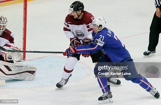 Antoine Roussel of France and Guntis Galvins of Latvia during the 2015 IIHF World Championship between Latvia and France at O2 arena ,on May 12,2015...