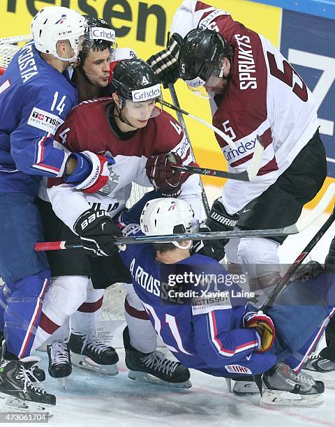 Antoine Roussel and Stephane Da Costa of France fights with Janis Andersons and Janis Sprukts of Latvia during the 2015 IIHF World Championship...