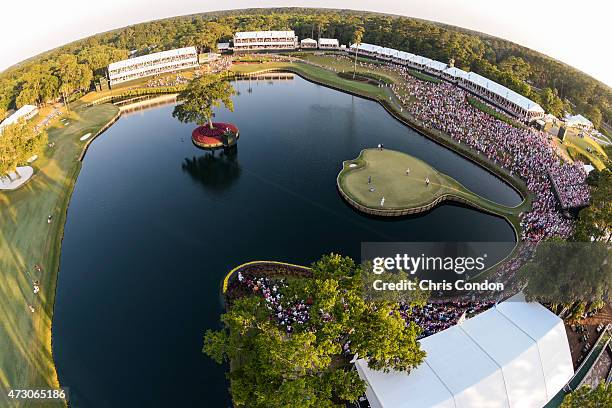 Course scenic as Kevin Kisner celebrates after making a birdie putt and Rickie Fowler reads his putt on the 17th hole island green during a playoff...