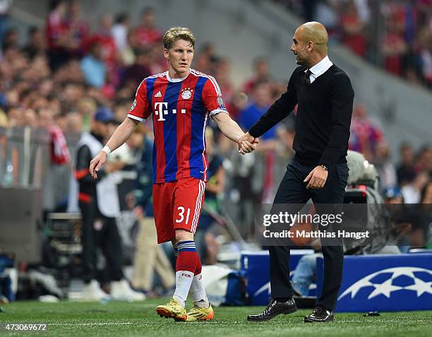 Bastian Schweinsteiger of Bayern Muenchen shakes hands with Josep Guardiola head coach of Bayern Muenchen during the UEFA Champions League semi final...