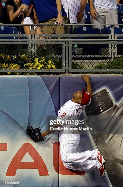 Ben Revere of the Philadelphia Phillies jumps and attempts to catch a home run in the fourth inning during a game against the Pittsburgh Pirates at...