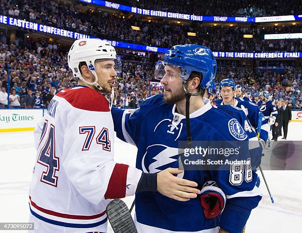 Nikita Kucherov of the Tampa Bay Lightning shakes hands with Alexei Emelin of the Montreal Canadiens after the series win after Game Six of the...