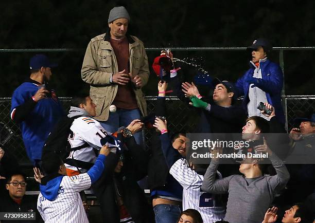 Fans in the new left field bleachers scramble to catch a home run ball hit by Kris Bryant of the Chicago Cubs in the 8th inning against the New York...