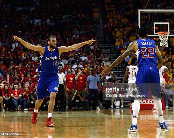 Spencer Hawes of the Los Angeles Clippers celebrates with Matt Barnes against the Houston Rockets during Game Five of the Western Conference...