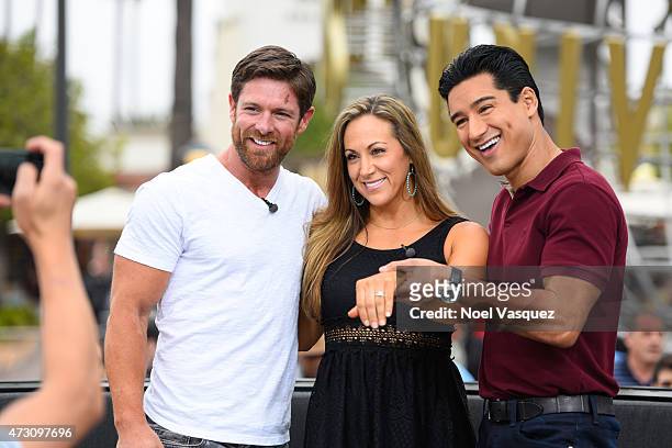Noah Galloway, Jamie Boyd and Mario Lopez display Jamie's engagement ring at "Extra" at Universal Studios Hollywood on May 12, 2015 in Universal...