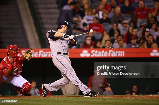 Justin Morneau of the Colorado Rockies breaks his bat during his at-bat in the sixth inning during the MLB game against the Los Angeles Angels of...