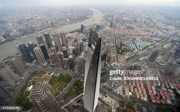 This picture taken on May 8, 2015 shows a view of the Shanghai World Financial Center from the 120th floor of the new Shanghai Tower, which is still...