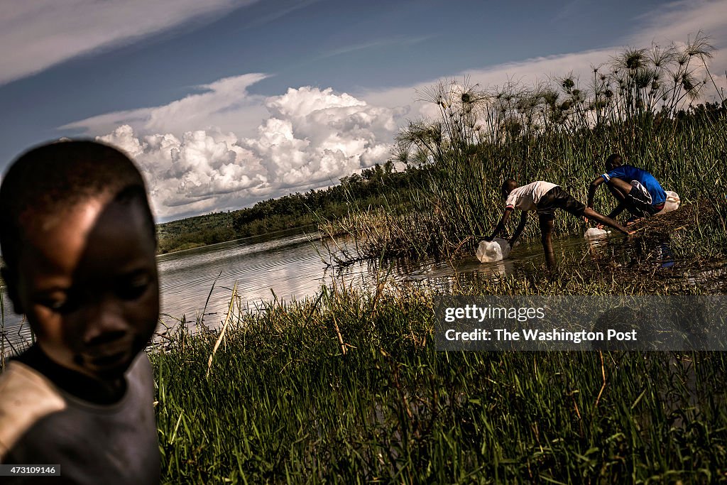 Young refugees from Burundi collect water from Lake Miravi at the refugee transit camp in Gashora, Bugesera, Rwanda Wednesday April 29, 2015.