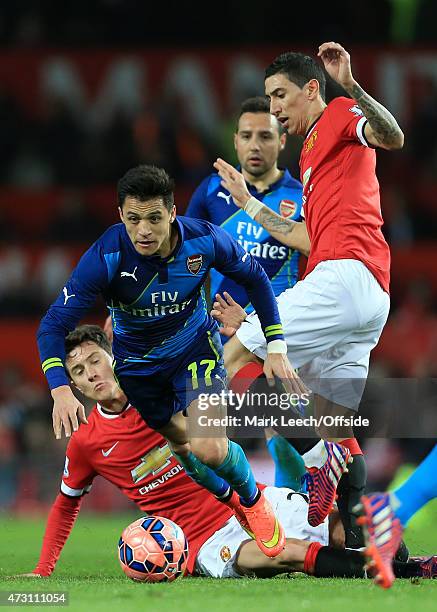 Alexis Sanchez of Arsenal gets between Angel Di Maria and Ander Herrera of Man Utd during the FA Cup Quarter Final match between Manchester United...