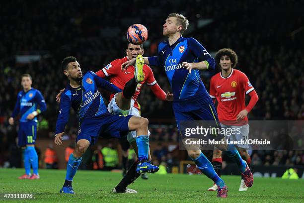 Chris Smalling of Man Utd battles with Francis Coquelin and Per Mertesacker of Arsenal during the FA Cup Quarter Final match between Manchester...