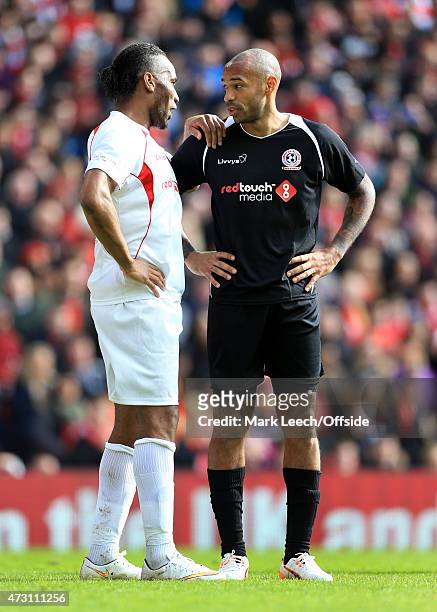 Didier Drogba chats to Thierry Henry during the Liverpool All-Star Charity match at Anfield on March 29, 2015 in Liverpool, England.