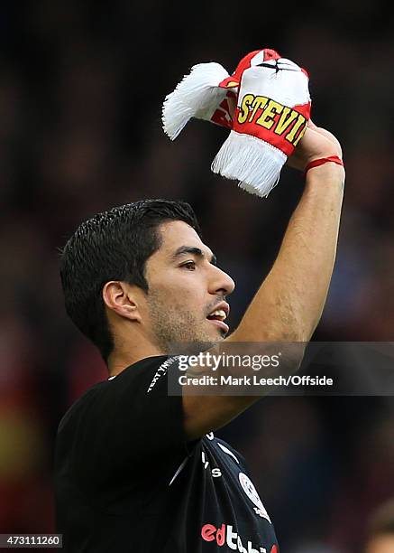 Luis Suarez throws a Liverpool scarf during the Liverpool All-Star Charity match at Anfield on March 29, 2015 in Liverpool, England.