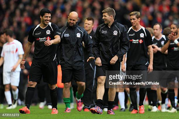 Luis Suarez shares a laugh with Steven Gerrard after the Liverpool All-Star Charity match at Anfield on March 29, 2015 in Liverpool, England.