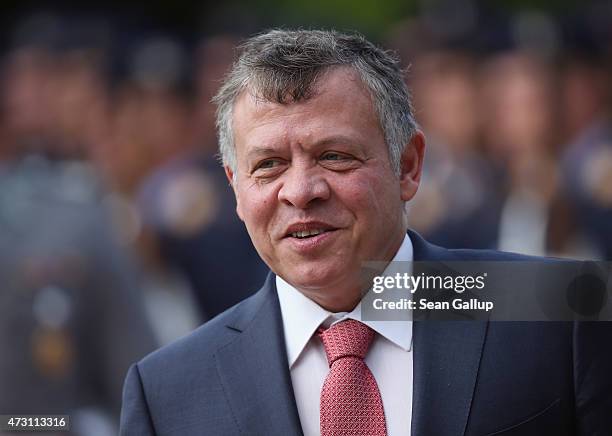 King Abdullah II of Jordan reviews a guard of honour with German President Joachim Gauck upon King Abdullah's arrival at Schloss Bellevue Palace on...