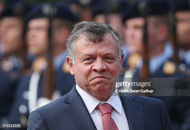 King Abdullah II of Jordan reviews a guard of honour with German President Joachim Gauck upon King Abdullah's arrival at Schloss Bellevue Palace on...