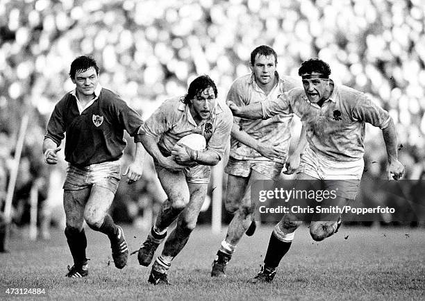 England forward Mike Teague carries the ball with Dean Richards and Wade Dooley in support during the Five Nations Championship rugby union match...