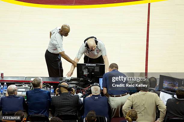 Referee Joe Crawford and Derrick Stafford reviews a play from the replay center in Secaucus, NJ during the game between the Cleveland Cavaliers and...