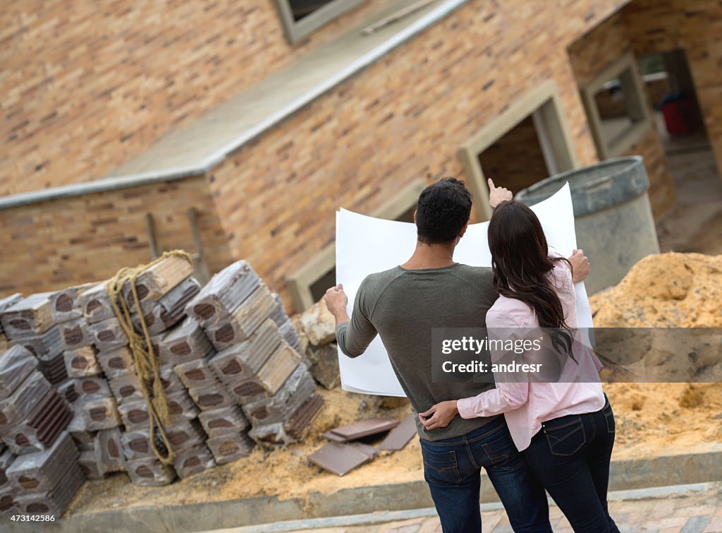 Couple looking at blueprints of their house