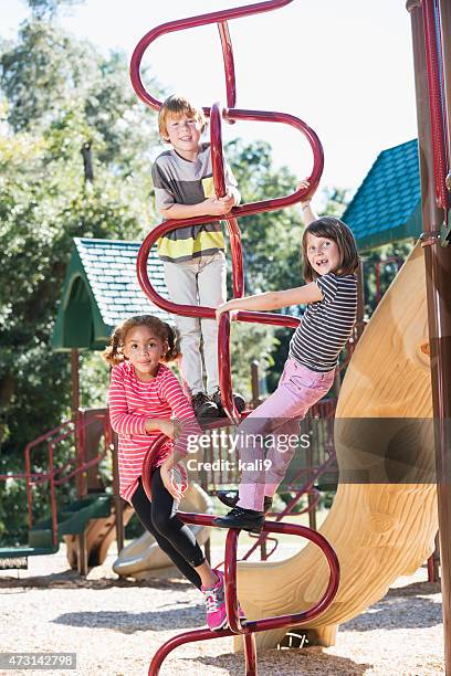 three children climbing on playground equipment - tag 7 bildbanksfoton och bilder