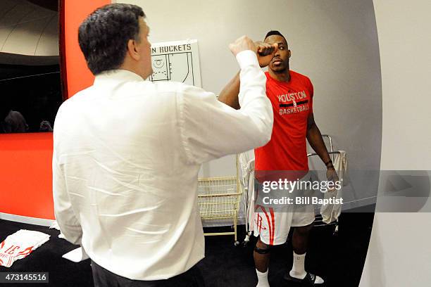 Head coach, Kevin McHale of the Houston Rockets fist bumps with Dwight Howard after the win against the Los Angeles Clippers for Game Five of the...