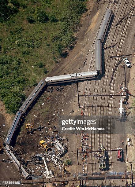 Investigators and first responders work near the wreckage of Amtrak Northeast Regional Train 188, from Washington to New York, that derailed...