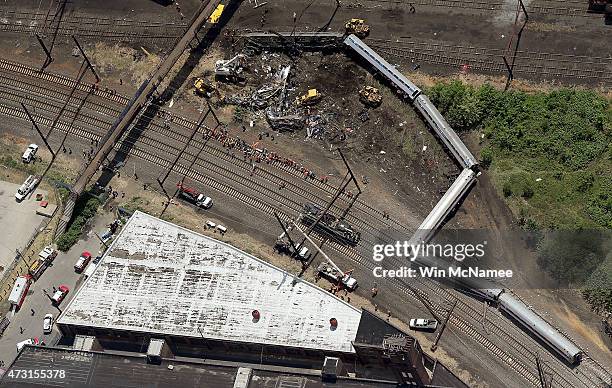 Investigators and first responders work near the wreckage of Amtrak Northeast Regional Train 188, from Washington to New York, that derailed...