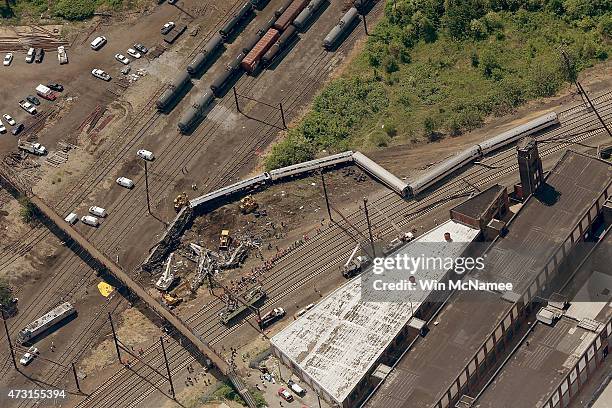 Investigators and first responders work near the wreckage of Amtrak Northeast Regional Train 188, from Washington to New York, that derailed...