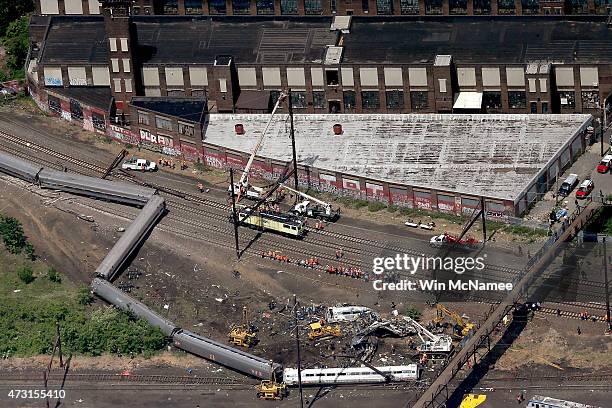 Investigators and first responders work near the wreckage of Amtrak Northeast Regional Train 188, from Washington to New York, that derailed...