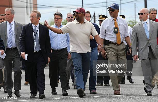 Philadelphia Mayor Michael Nutter , walks with members of the investigation team near the wreckage of Amtrak Northeast Regional Train 188, from...