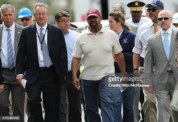 Philadelphia Mayor Michael Nutter , walks with members of the investigation team near the wreckage of Amtrak Northeast Regional Train 188, from...