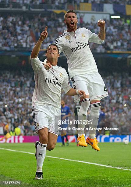 Cristiano Ronaldo of Real Madrid celebrates with teammates Sergio Ramos of Real Madrid after scoring the opening goal from the penalty spot during...