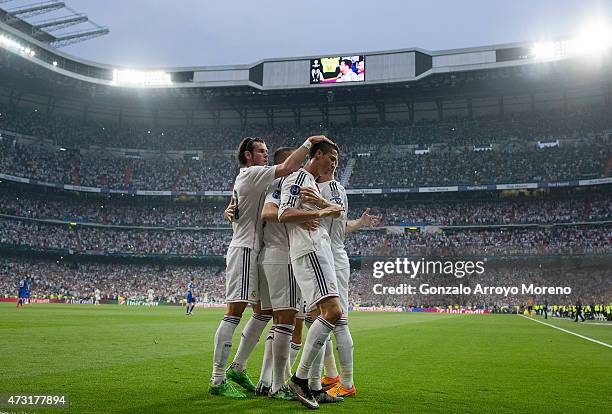 Cristiano Ronaldo of Real Madrid celebrates with teammates after scoring the opening goal from the penalty spot during the UEFA Champions League Semi...