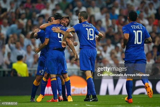 Alvaro Morata of Juventus is congratulated by teammates after scoring a goal to level the scores at 1-1 during the UEFA Champions League Semi Final,...