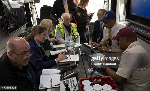 In this handout image supplied by NTSB, NTSB IIC Mike Flanigon briefs Philadelphia Mayor Michael Nutter on the scene of the Amtrak Train derailment...