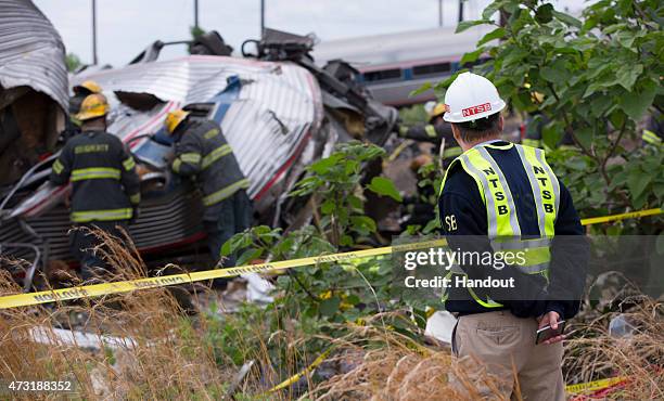 In this handout image supplied by NTSB, NTSB member Robert Sumwalt works on the scene of the Amtrak Train derailment on May 13, 2015 in Philadelphia,...